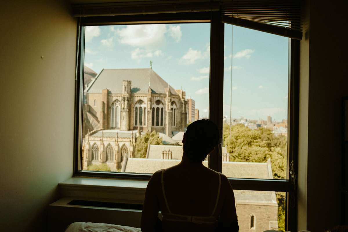 Feisty looking through a window toward a church