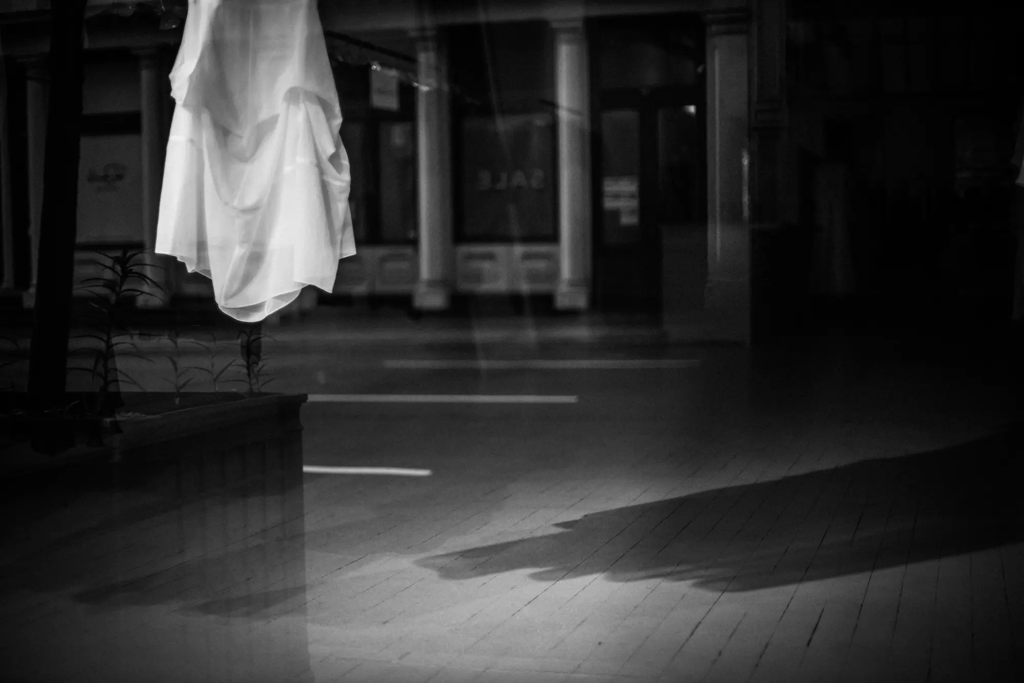 Fabric suspended inside a dark storefront