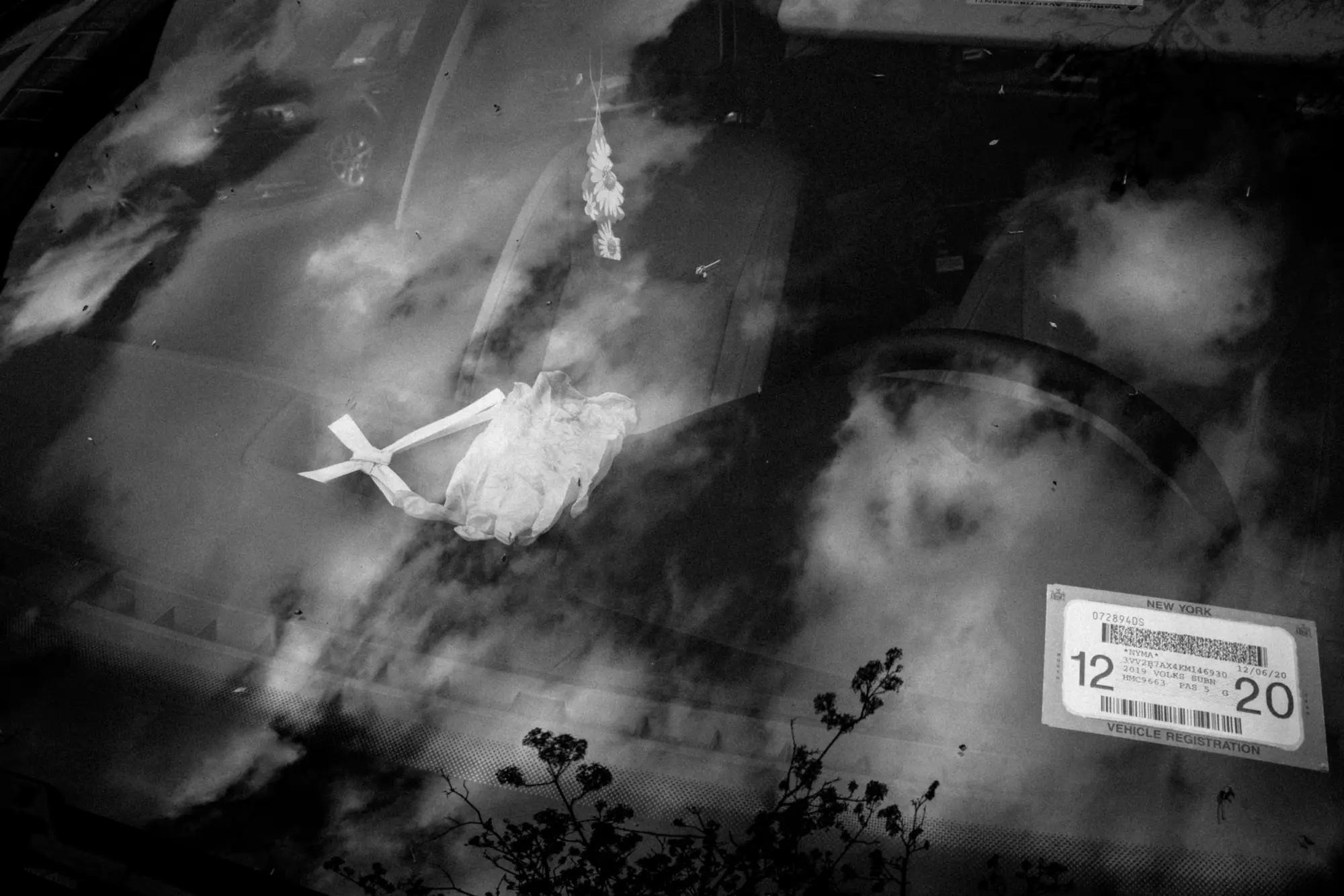 Clouds and a figure reflected in glass