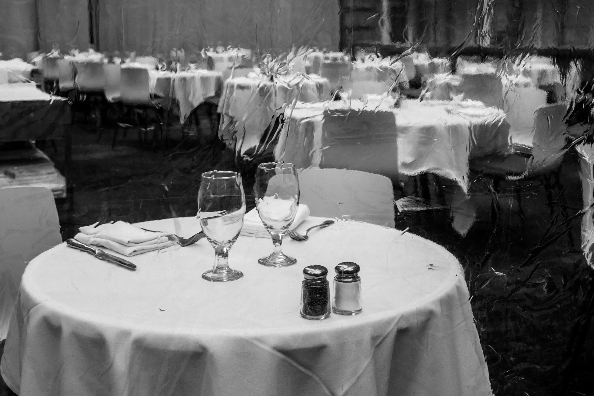 Empty restaurant tables set with white cloths